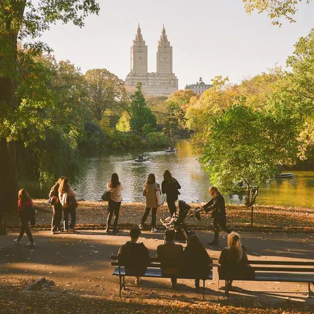Visitors take in the view of the lake and skyline in Central Park, New York