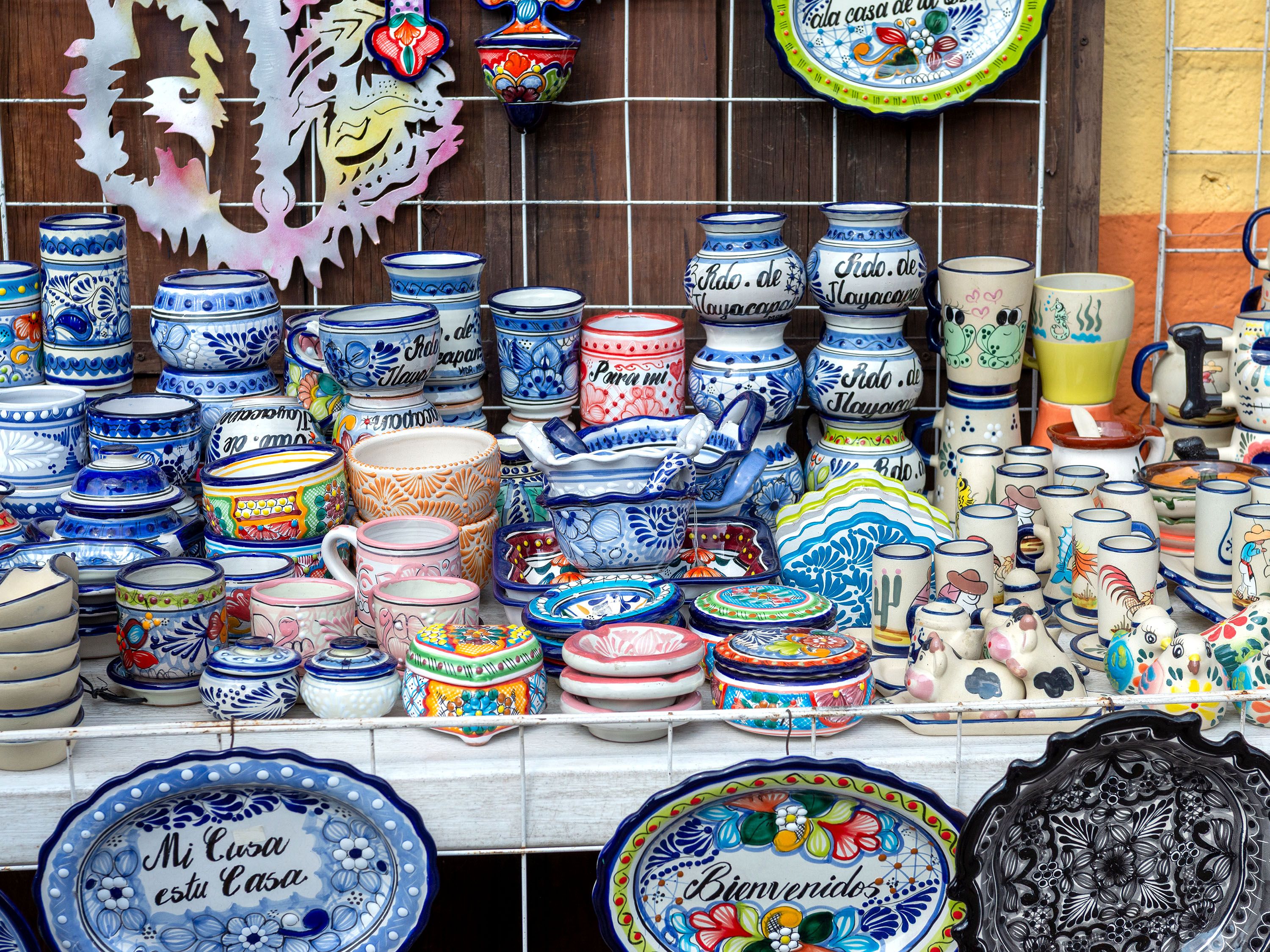 Colorful pottery stacked on a table.