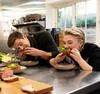 Antoni Porowski and Florence Pugh take big bites out of stuffed Yorkshire puddings. Photos: National Geographic/Chris Raphael