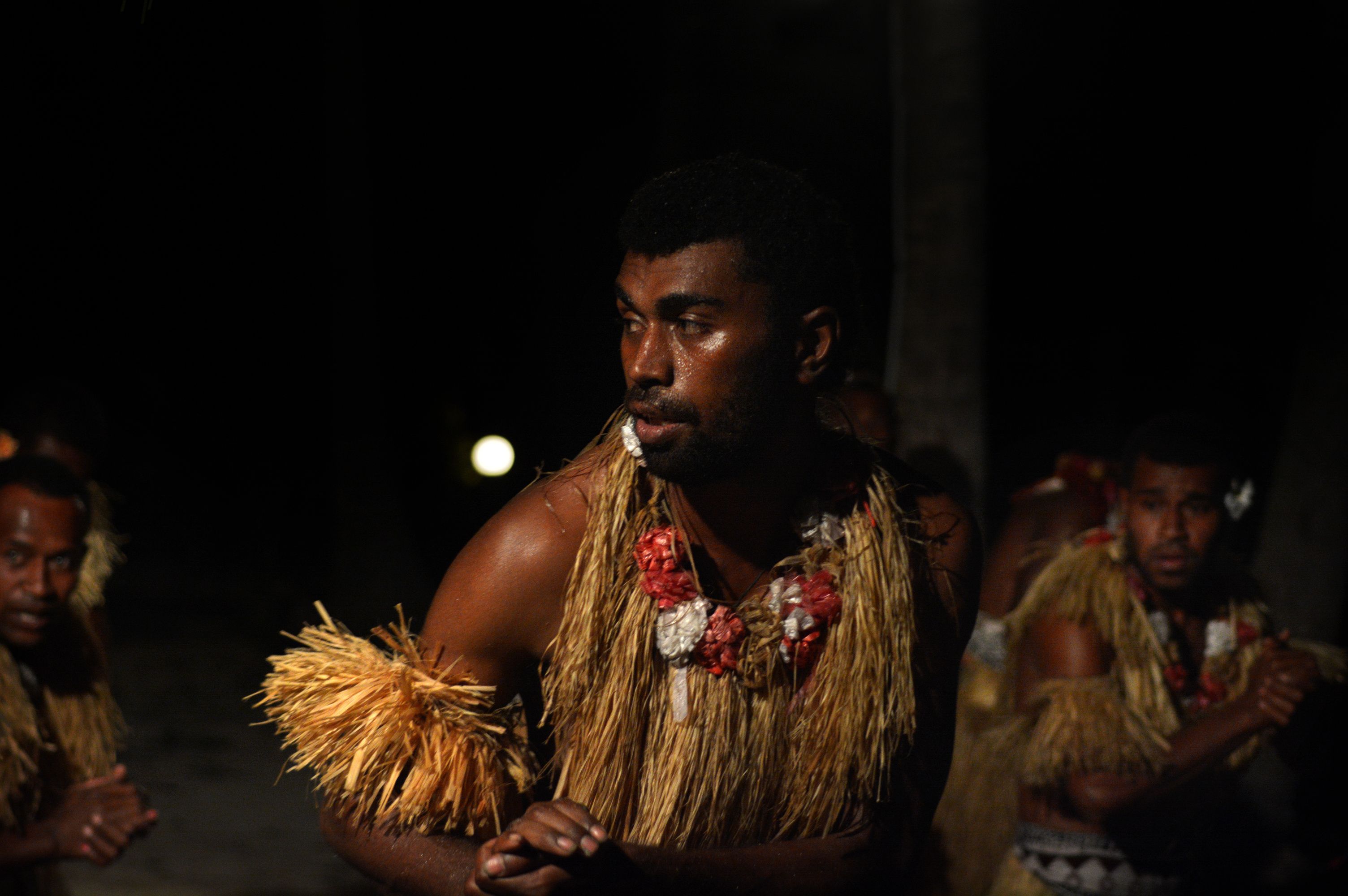 A Fijian dancer brings the powerful meke wesi to life under the island night.