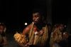 A Fijian dancer brings the powerful meke wesi to life under the island night.