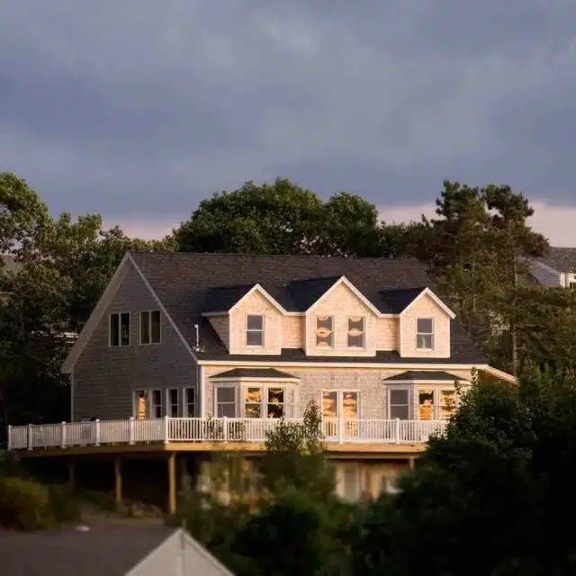 A huge waterfront Vrbo on Bailey Island, reflected in the water
