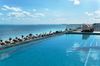 Rooftop infinity pool meets endless Caribbean blue.