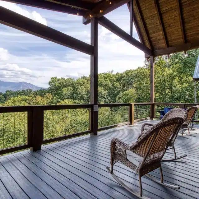 Rocking chairs on the deck look out over the trees