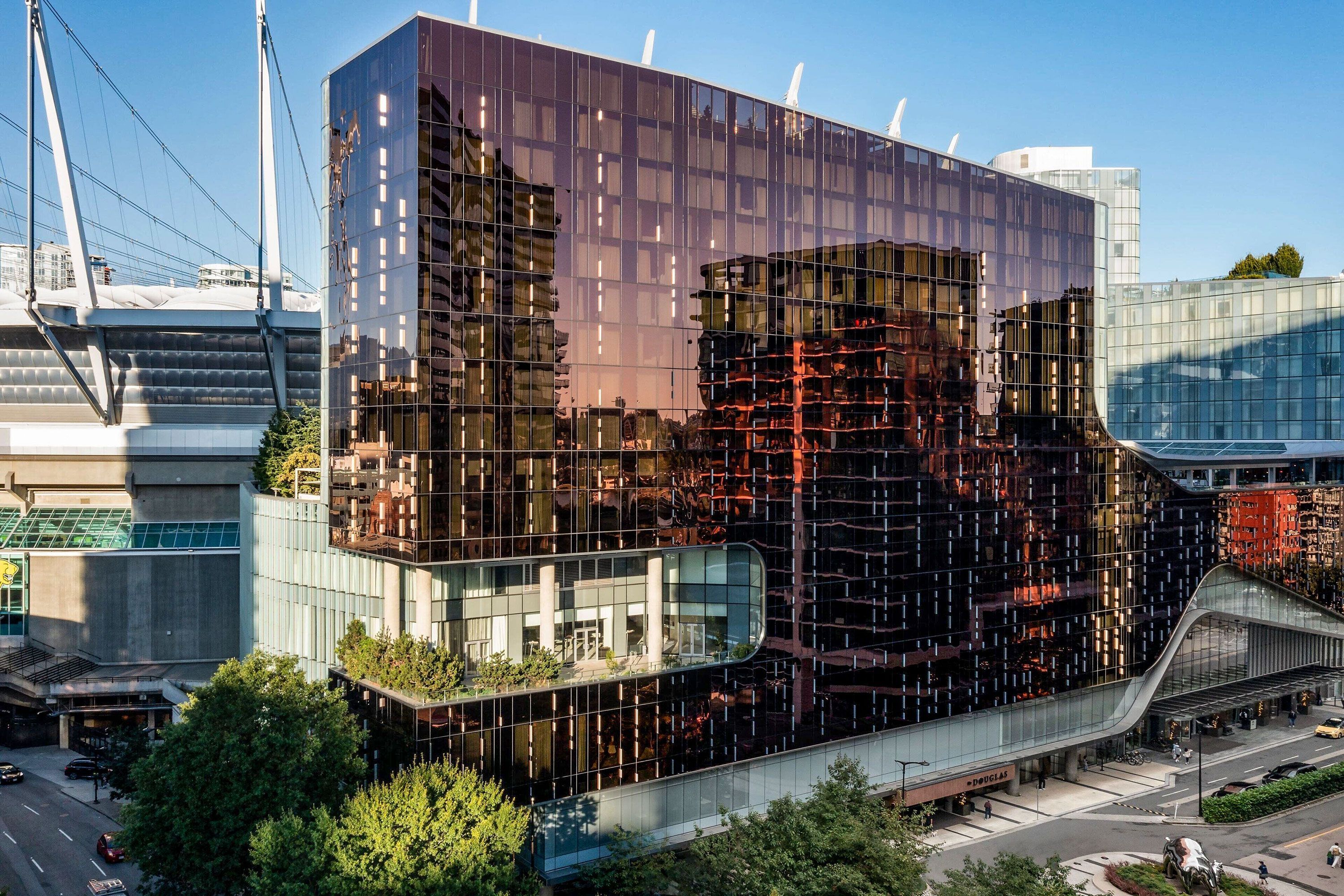 A gleaming, modern, and high-tech structure with a unique copper-colored façade.