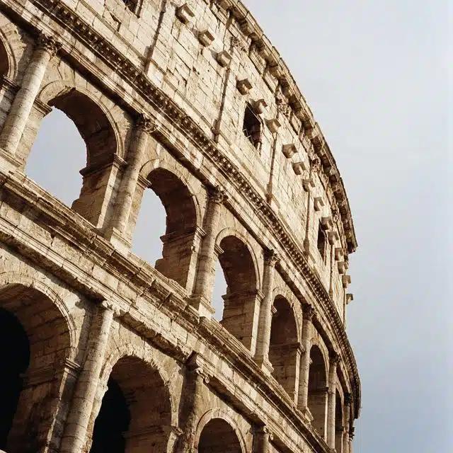 A partial view of the Colosseum against the sky
