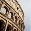 A partial view of the Colosseum against the sky