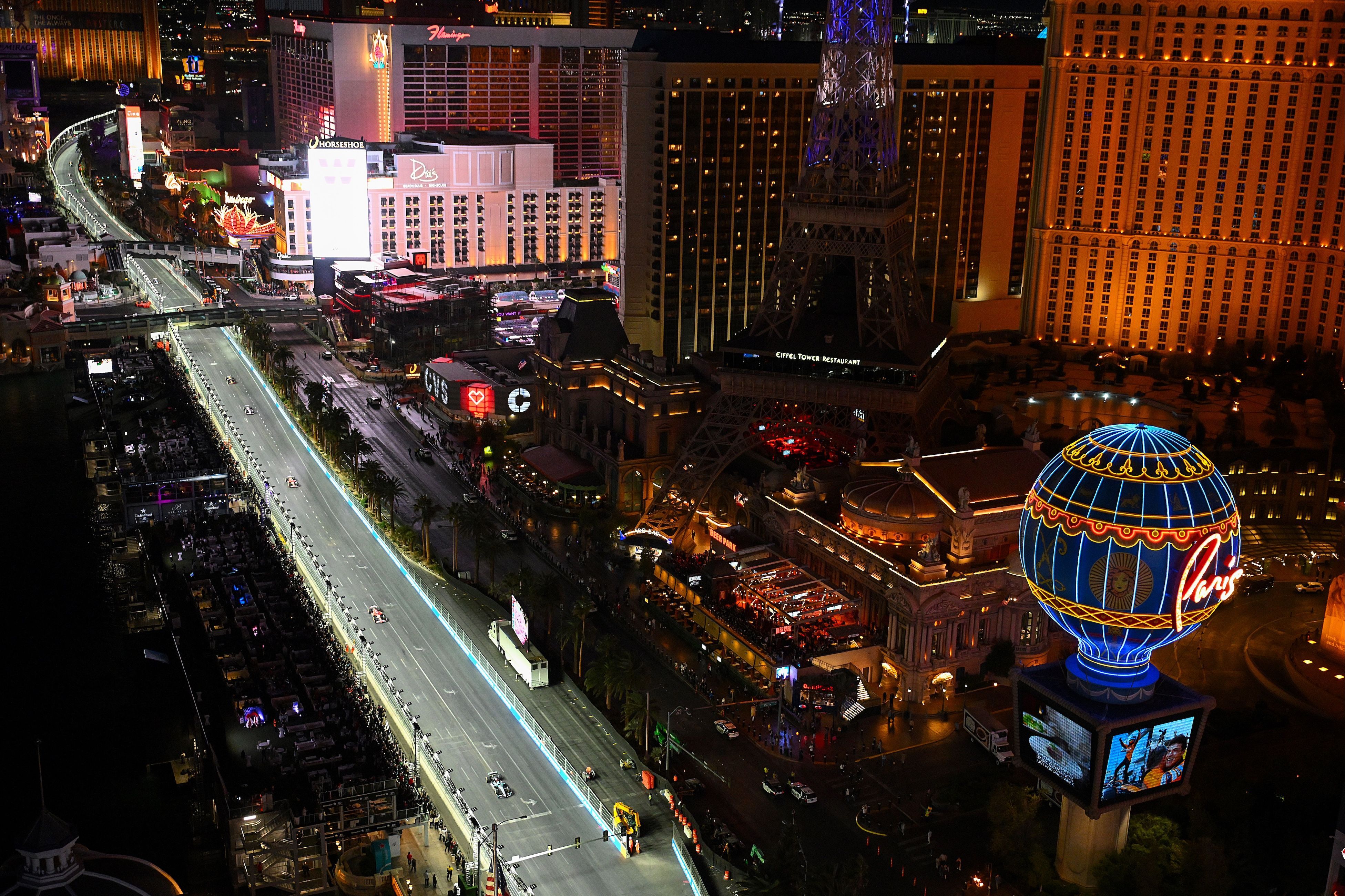 An overhead view of the Las Vegas Strip Circuit during the F1 Grand Prix of Las Vegas and the surrounding neon-lit buildings in Las Vegas, Nevada