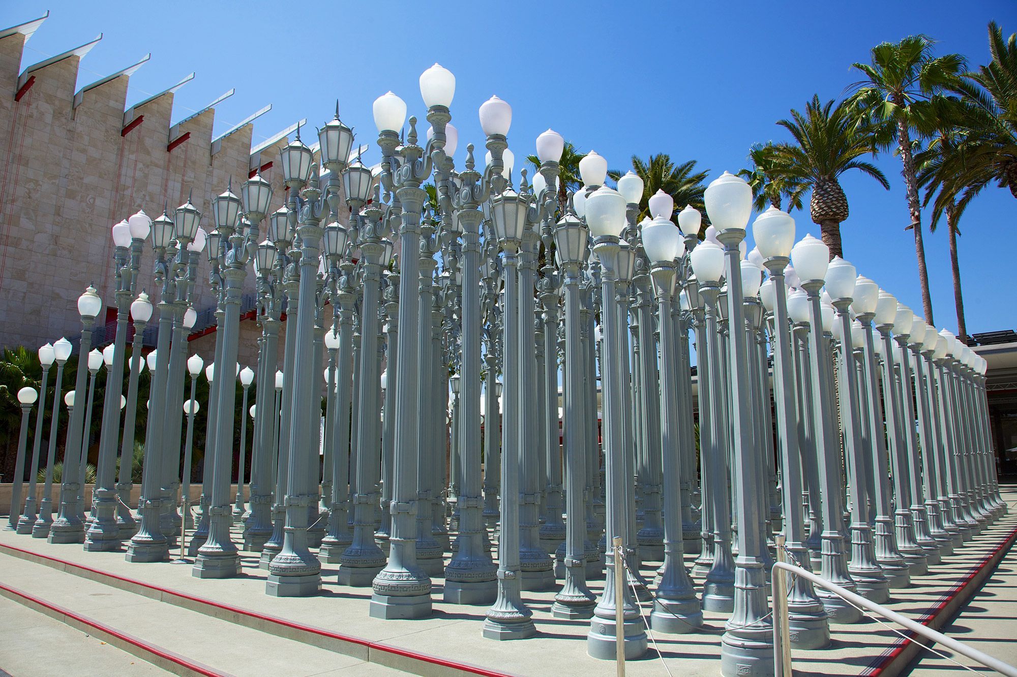 A group of street lamps clumped together on a sidewalk in Los Angeles.