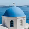 The blue-domed church of Spirydon in Santorini, Greece