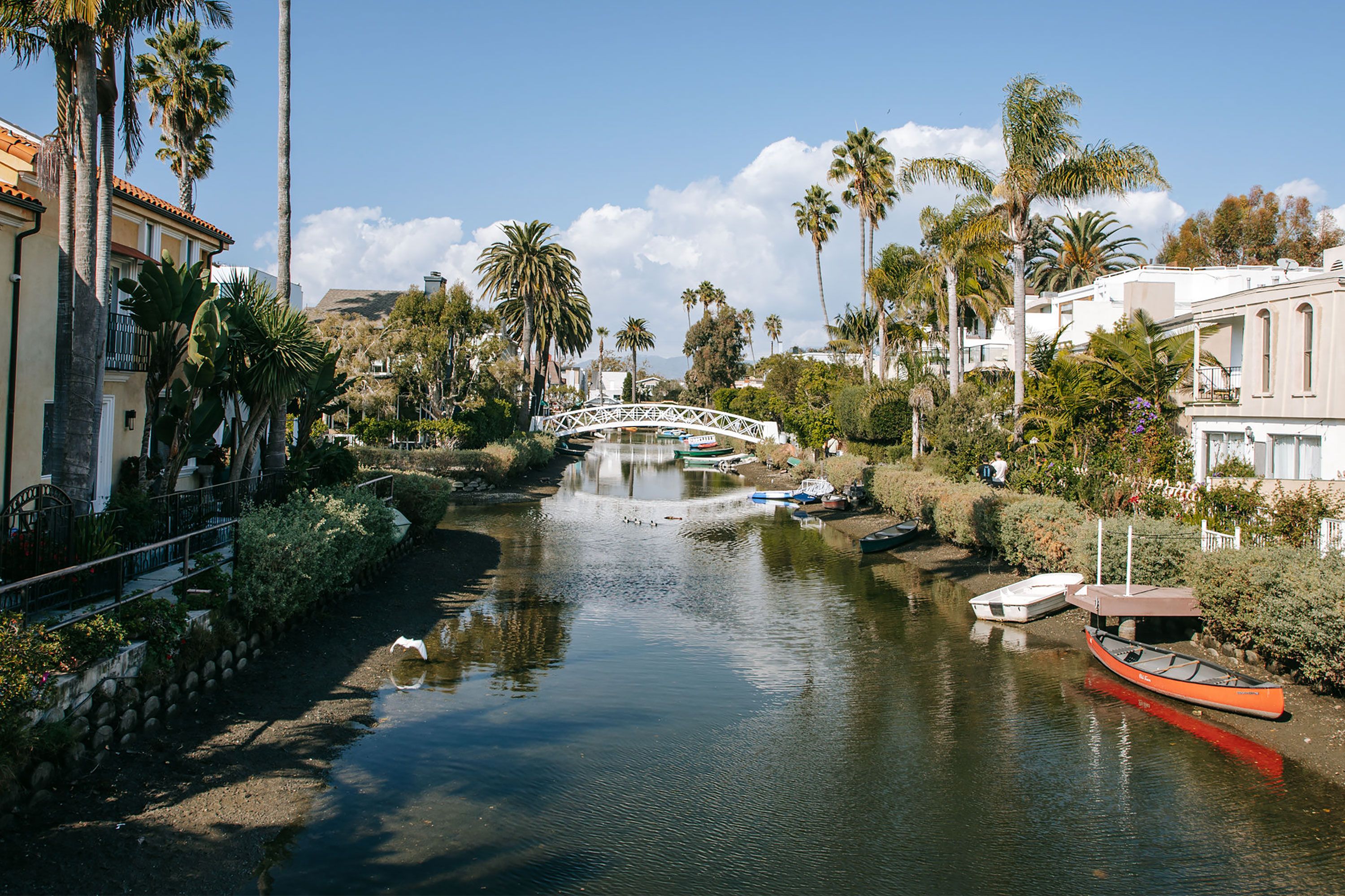 A small white bridge over a canal. 