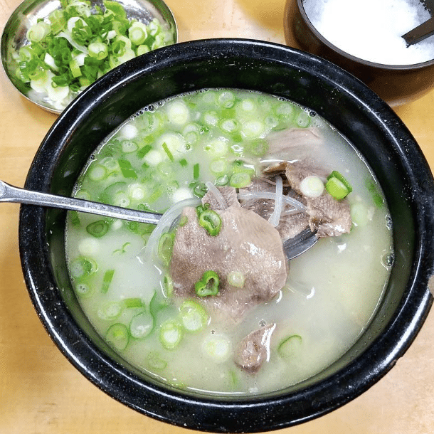 A milky-white broth with meat and scallions is served at Han Bat Sul Lung Tang in Koreatown, Los Angeles