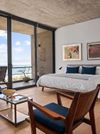 A stylish bedroom of a Vrbo with sea views