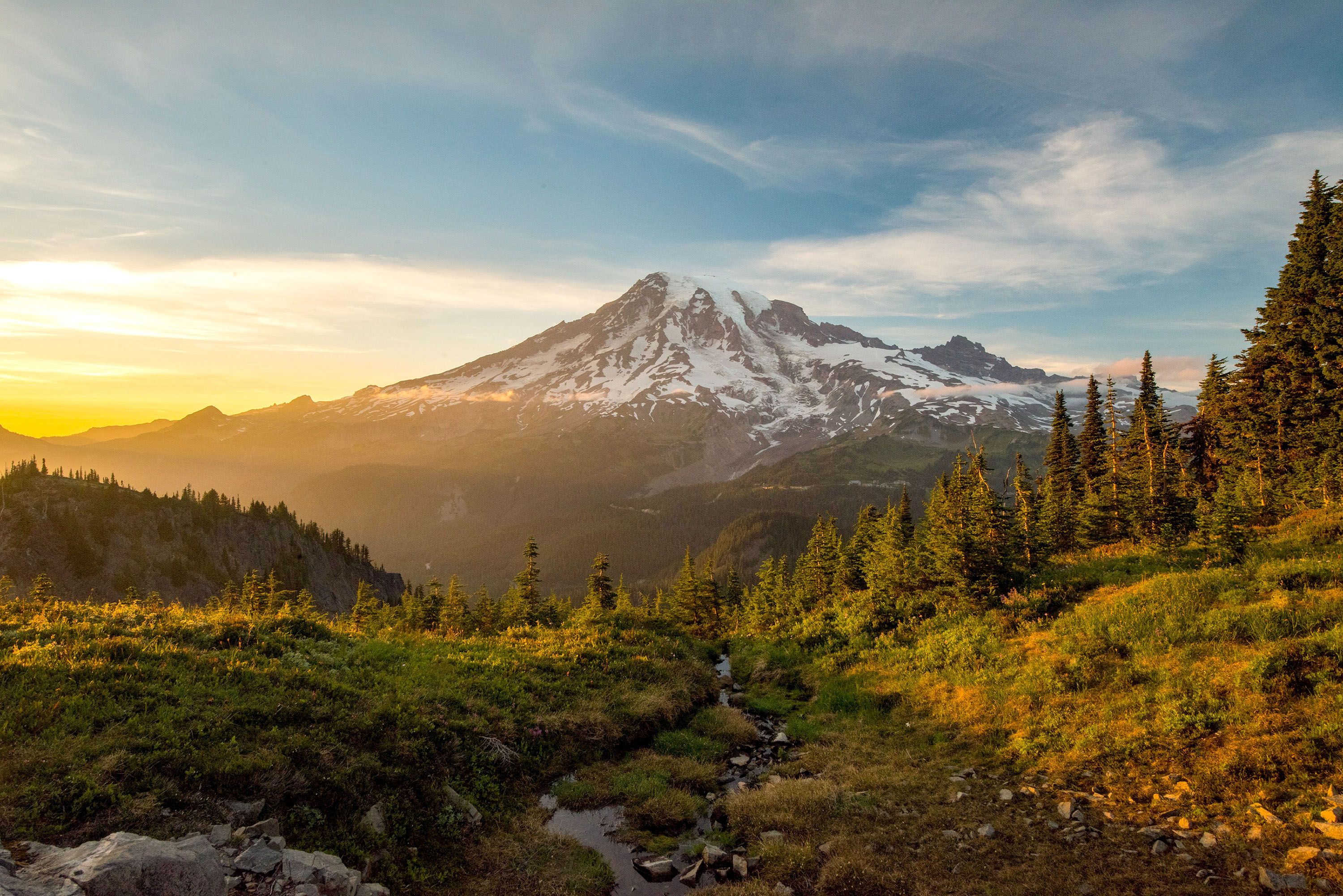 The snowy slopes of Mount Rainier at sunset.