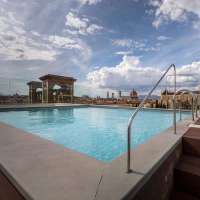 The rooftop pool at Plaza Hotel Lucchesi on a bright, partly cloudy day in Florence, Italy