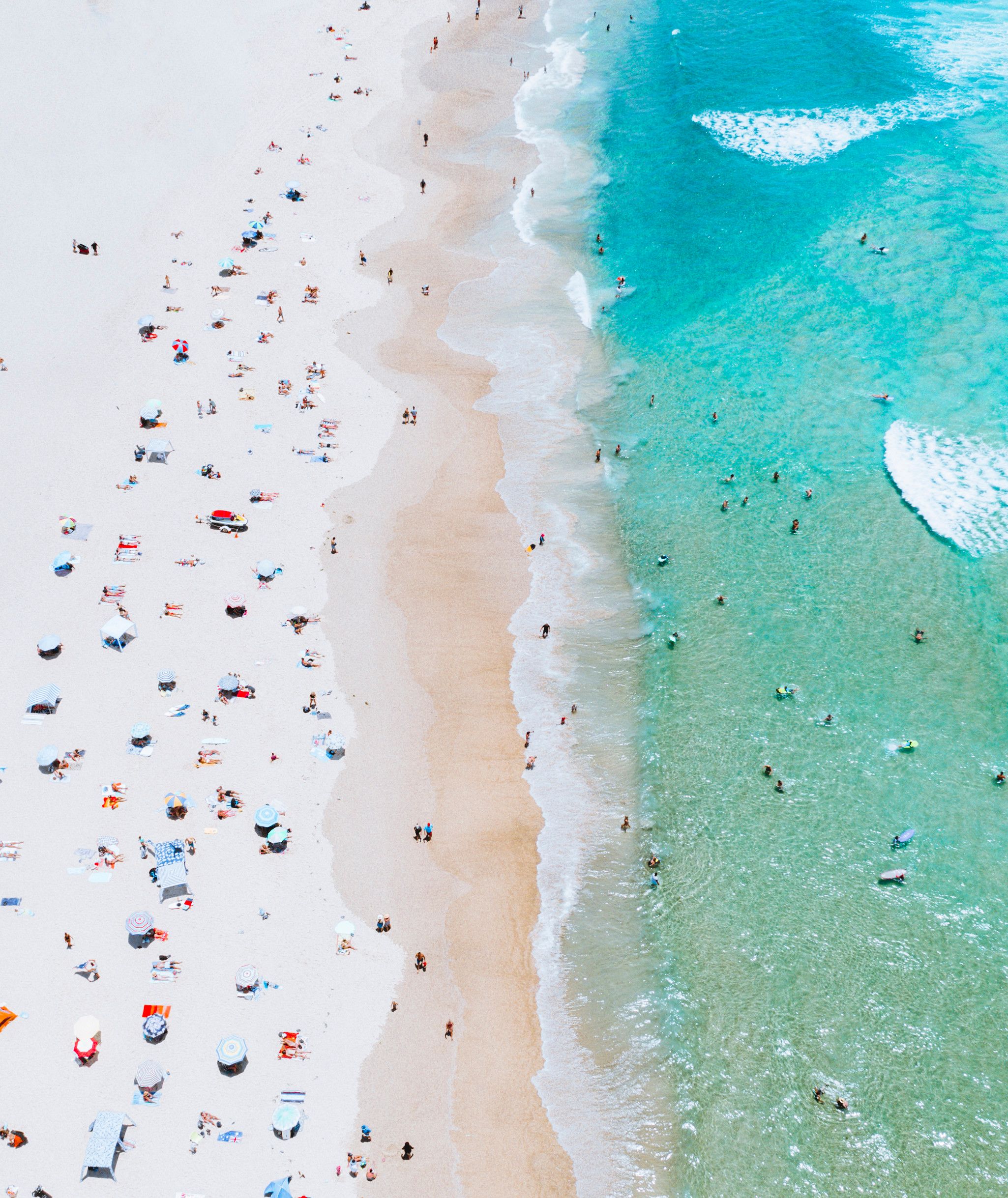 An aerial view of the Gold Coast beach with people sunbathing on the sand