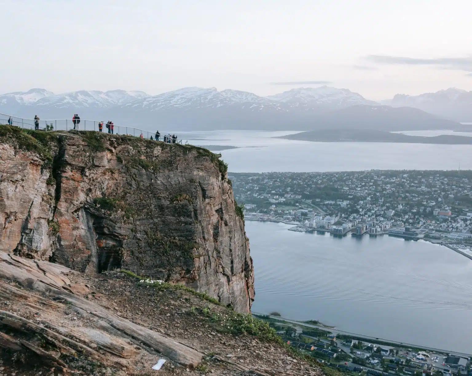 Travelers take in the view of Tromsø port, from the mountains opposite