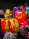 Colorfully hand painted lanterns, one with a smiley face and ruffles, are paraded through the streets for St. Martin’s Day, in the Netherlands