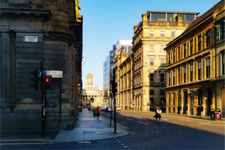 On one Glasgow's  buzzy streets, one side is soaked in sunlight while the other sits in cool shadows