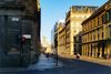 On one Glasgow's buzzy streets, one side is soaked in sunlight while the other sits in cool shadows