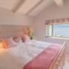 A pretty bedroom in Greece decorated in tonal shades of pink