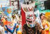 People wear colorful masks as part of the Phi Ta Khon ghost festival parade in Thailand