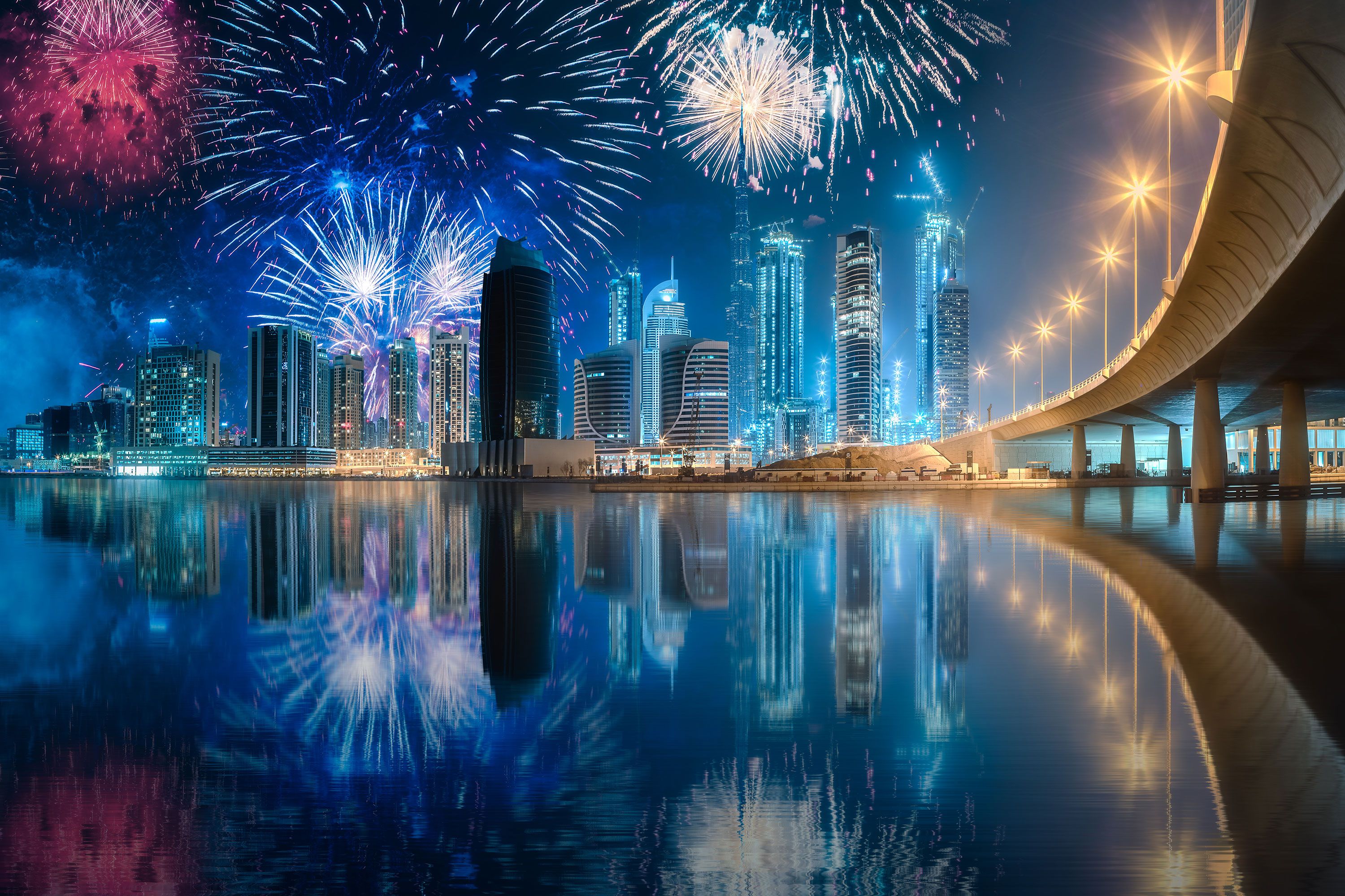 Colorful fireworks display above skyscrapers of Dubai Business Bay.