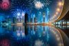 Colorful fireworks display above skyscrapers of Dubai Business Bay.