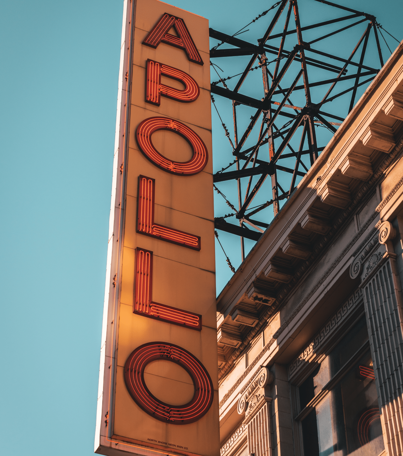 A close-up of the red neon sign in front of the Apollo Theater in Harlem, New York
