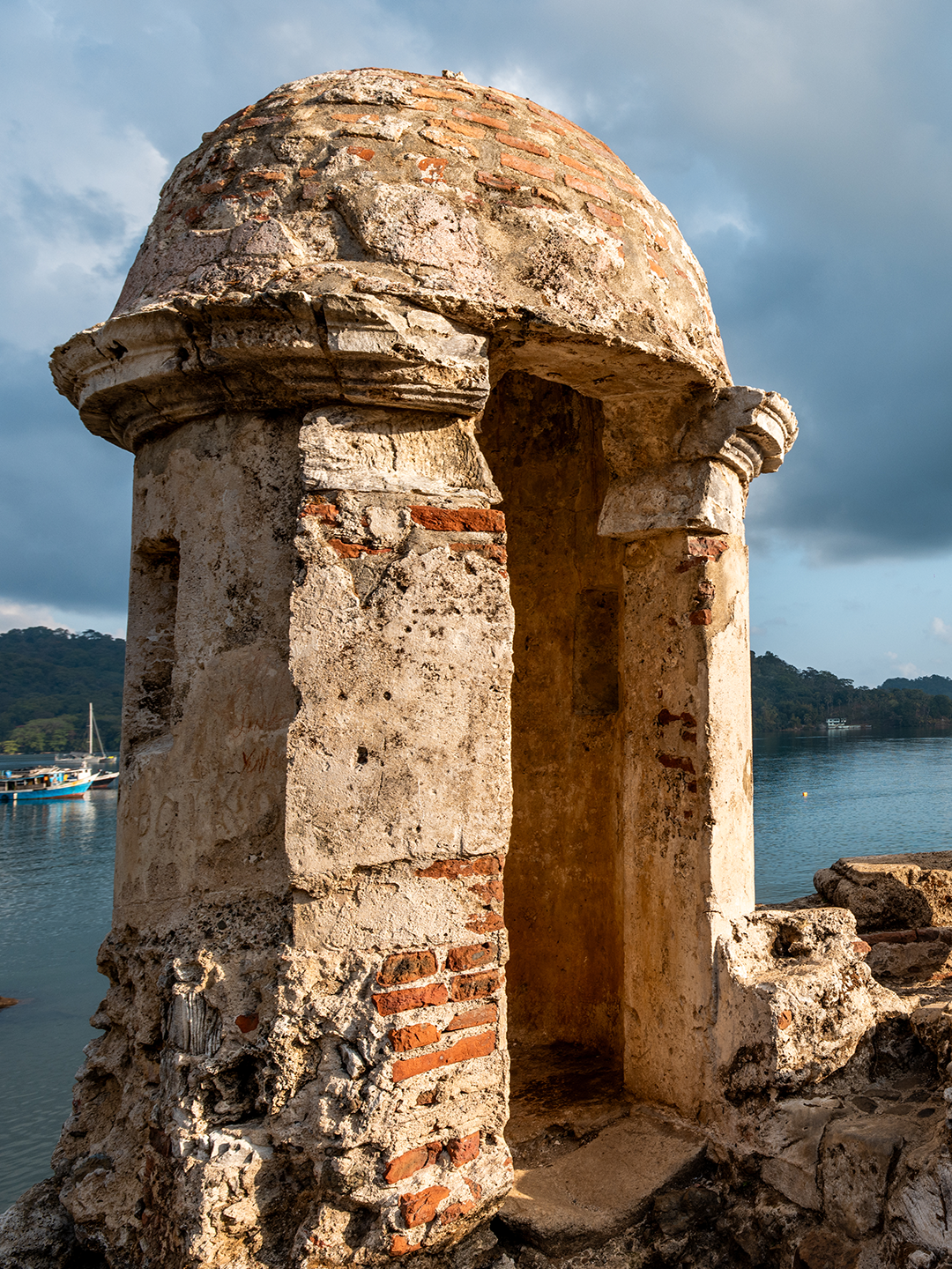 An old heritage structure stands before the ocean in Portobelo in Panama