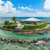 A large Vrbo on a private island, with turquoise sea surrounding it