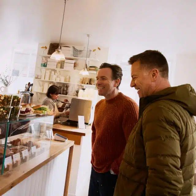 Ewan McGregor and his brother Colin McGregor pause for sandwich at the Aran Bakery, Scotland