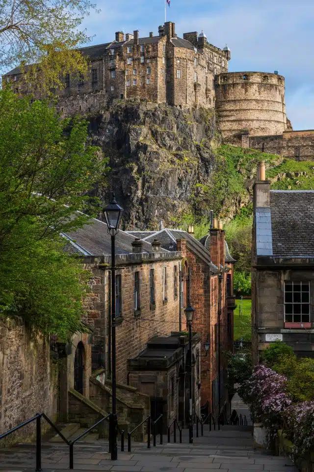Edinburgh’s Vennel Steps with castle and blue sky in background