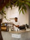 A barista steams milk behind the counter at Sisu Coffee Studio in Casco Antiguo, Panama