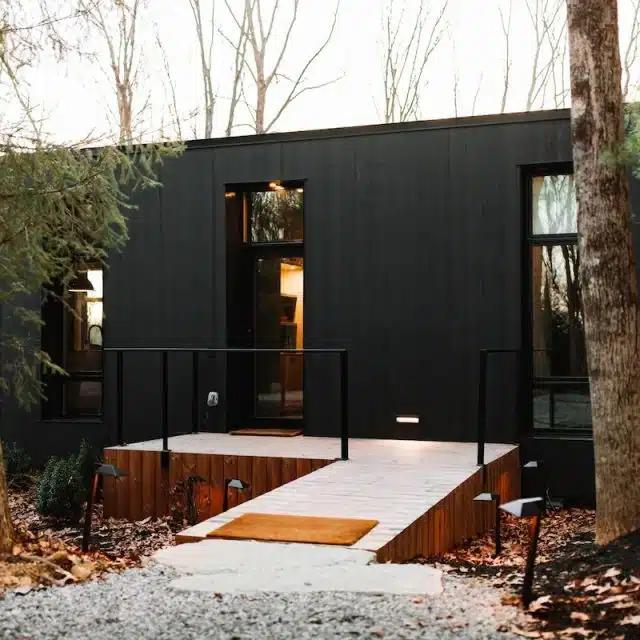 A ramp leads up to the chic black cabin Vrbo