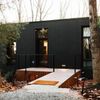 A ramp leads up to the chic black cabin Vrbo