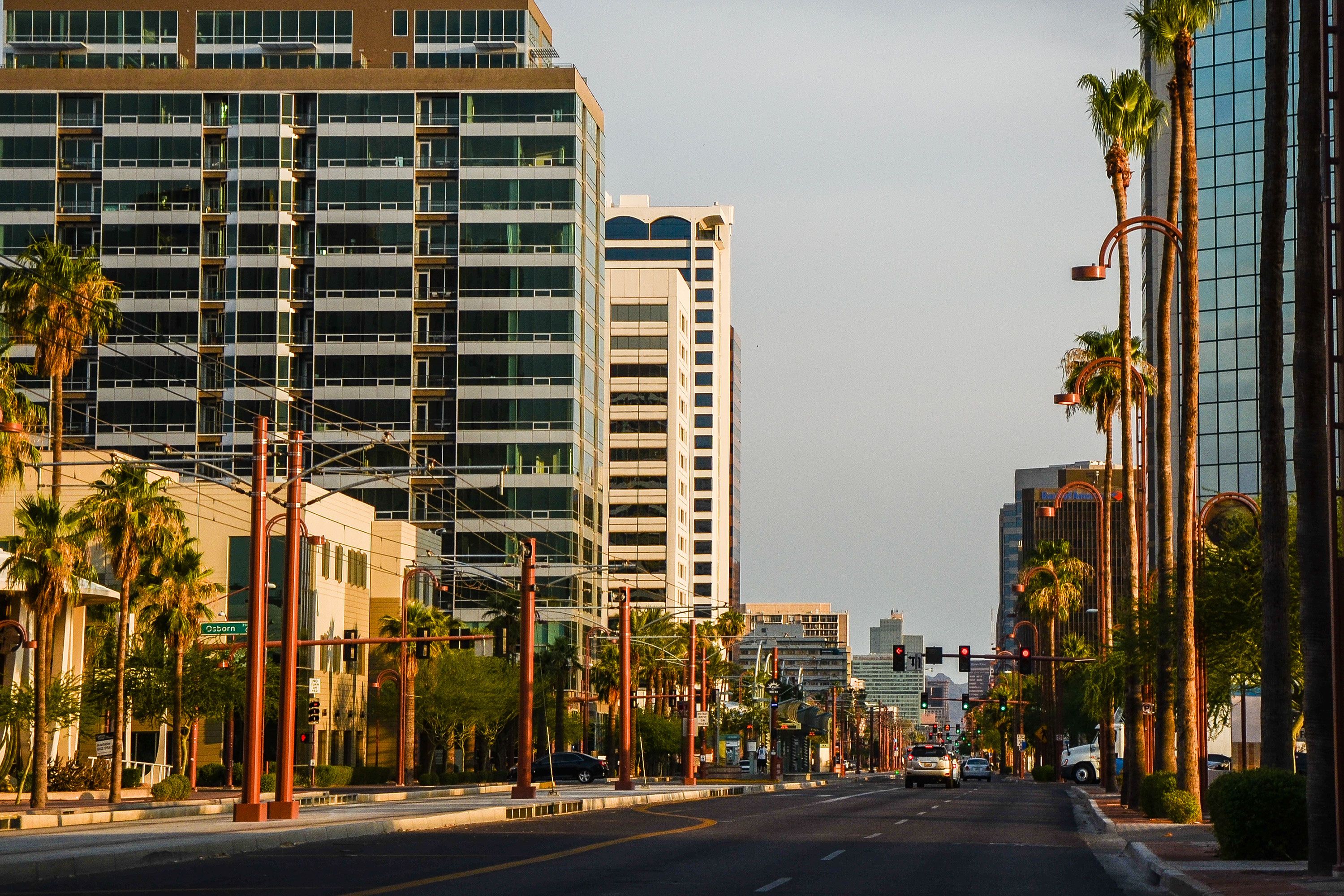 Skyscrapers and office towers in Midtown Phoenix, Arizona, set against a bright blue sky.