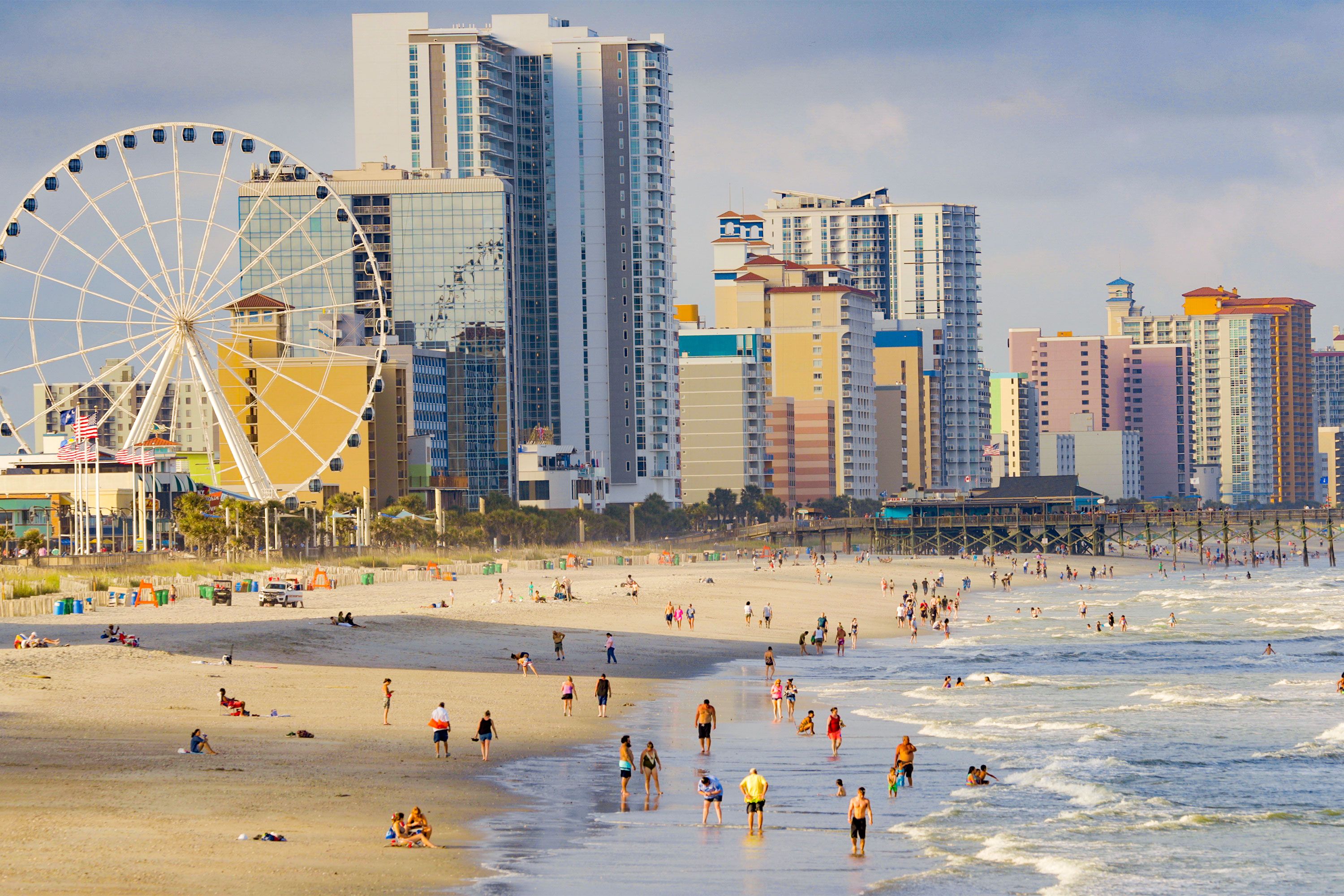 A bustling shoreline, high-rise hotels, and a Ferris wheel.