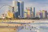 A bustling shoreline, high-rise hotels, and a Ferris wheel.