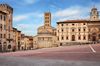 The main square Piazza Grande with the medieval church and buildings in Arezzo, Italy.