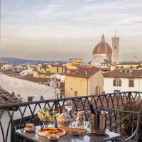 Breakfast is served on the balcony overlooking the city at The Place Firenze hotel in Florence, Italy