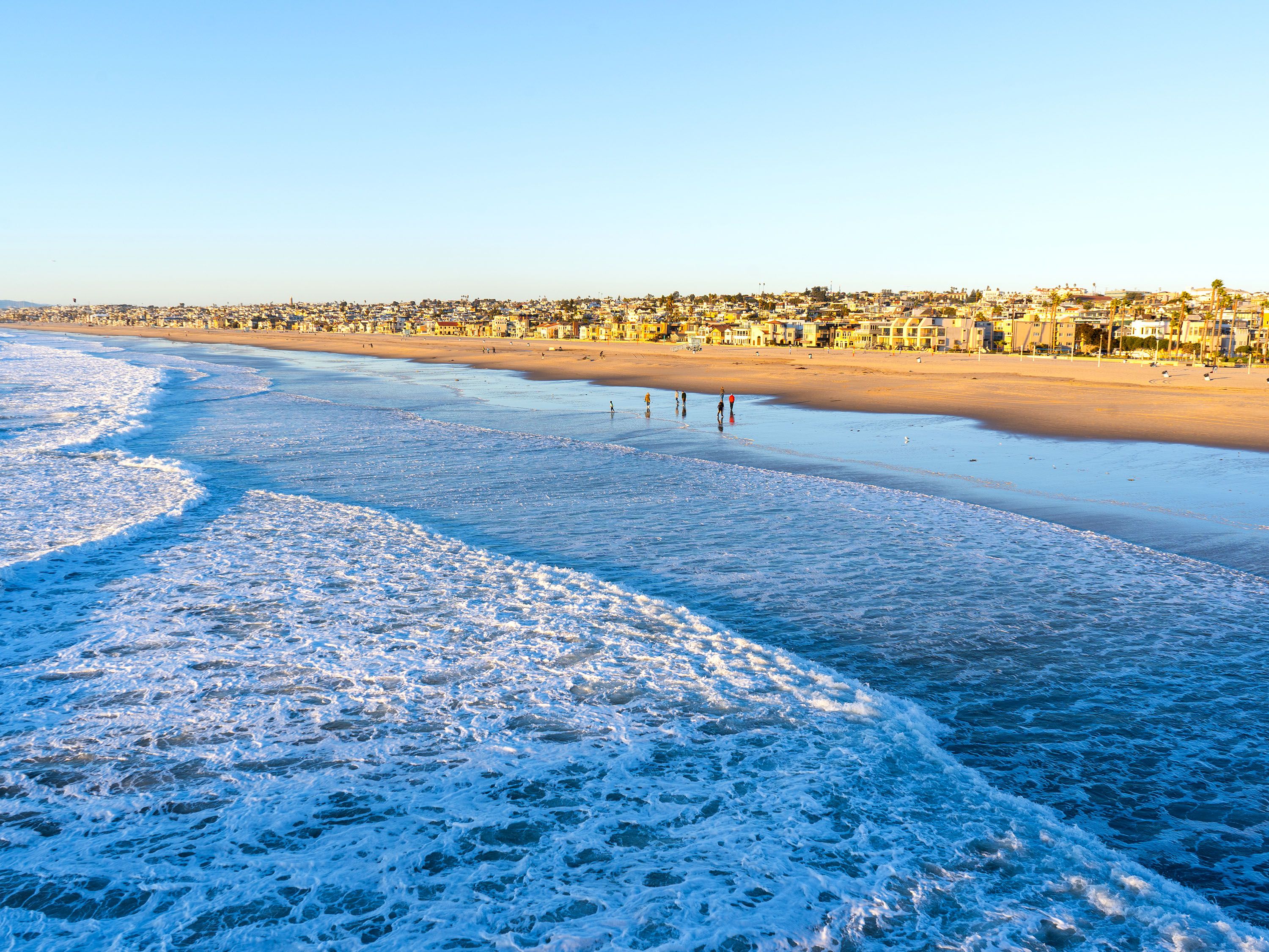 Lapping ocean waves and sandy beach.