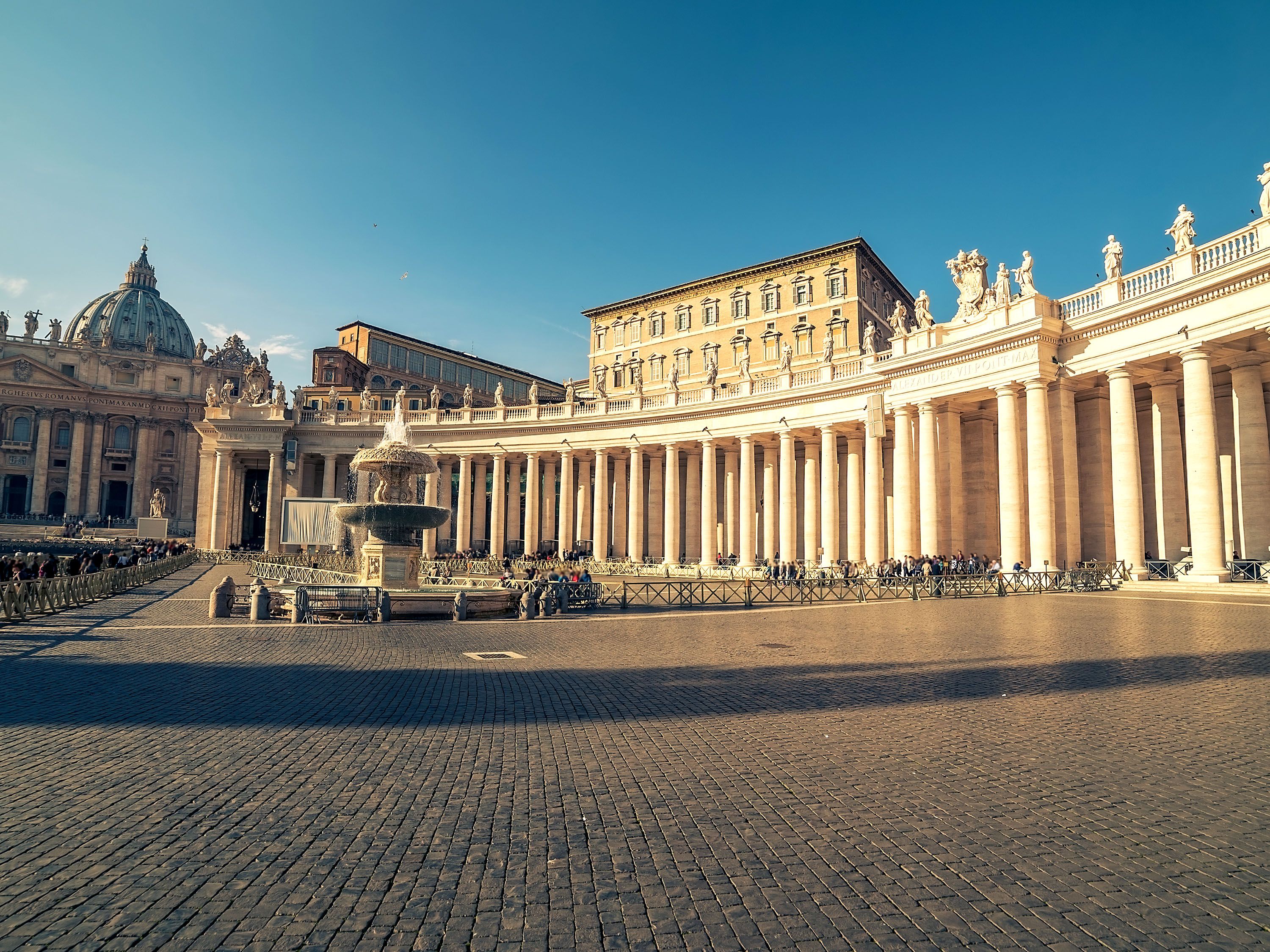 Fountain surrounded by building with pillars in St. Peter Square.