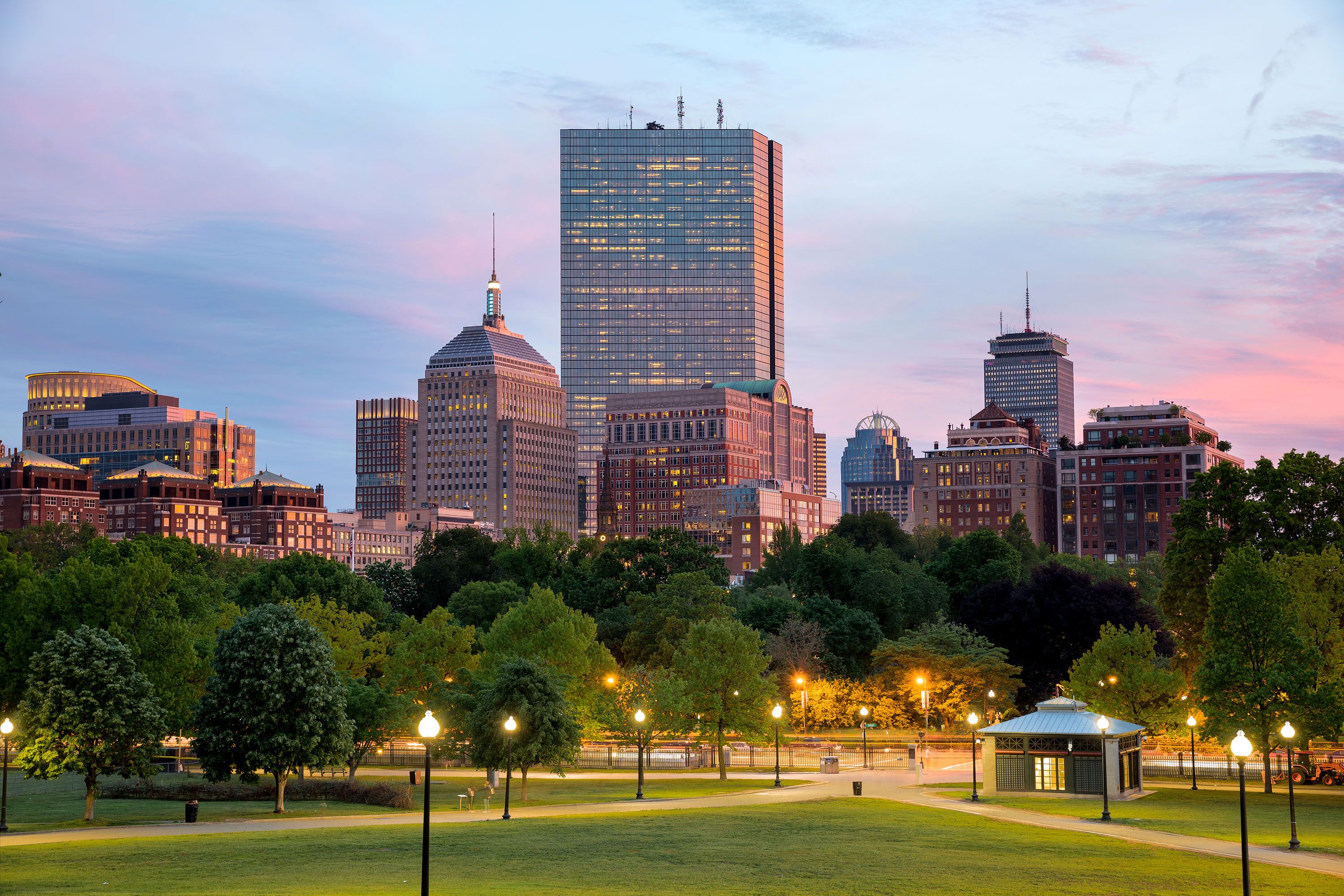 Boston Common green area in evening lighting, the city skyline in the background.