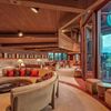Curved sofas and floor-to-ceiling windows follow Frank Lloyd Wright's distinctive style at a Vrbo in Hawaii