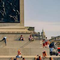 Children play at the base of Nelson's Column, Trafalgar Square, London