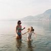 Artist Meghan Bustard in a lake with her daughter