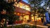 A mid-century chalet illuminated by lights in Winter Park, Colorado