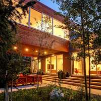 A mid-century chalet illuminated by lights in Winter Park, Colorado