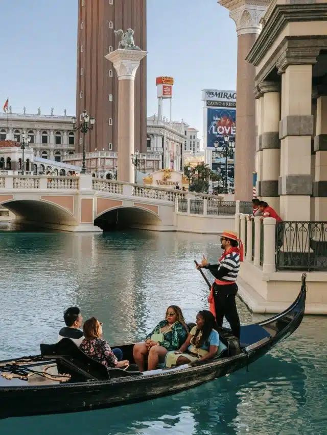 A family rides in a gondola on the water surrounding The Venetian hotel in Las Vegas, Nevada